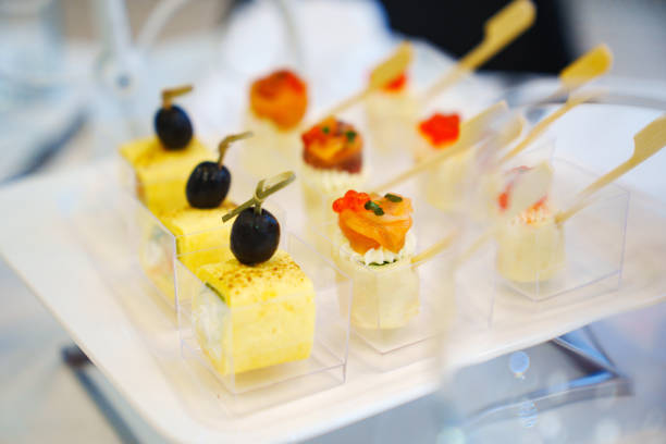 Canapes and rolls in banquet cups. Original snacks for the buffet. catering