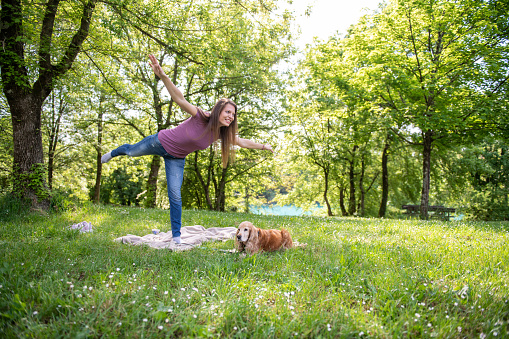 Doing yoga outdoors with the dog company