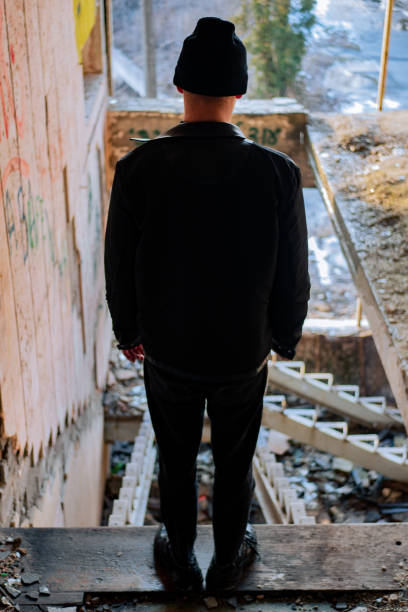 Sad teenager boy sitting at floor at the corridor