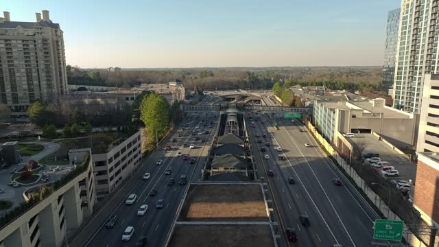 Traffic And Pedestrian Footbridge Over The Highway In Atlanta, Buckhead District, Georgia USA. Aerial Shot