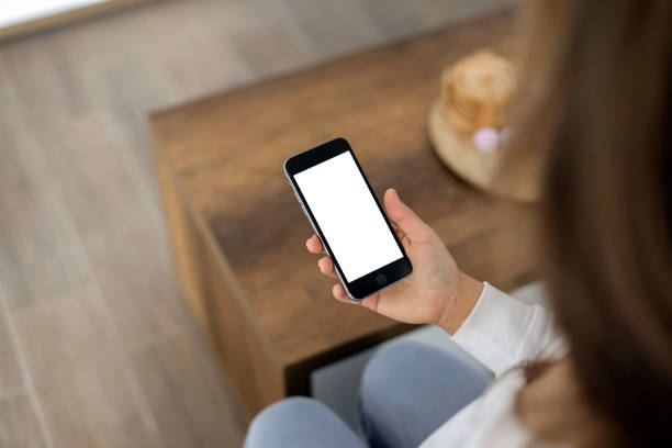 istock Young woman looking at a smart phone 2148983738