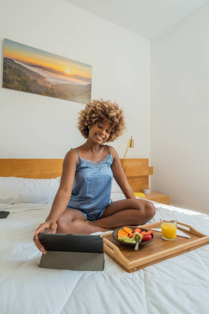 istock Woman on bed reading digital tablet 2148984669