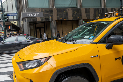 New York City, USA - April 7, 2018: Manhattan NYC buildings of midtown Herald Square Korean Town Korea Way road sign on west 32nd street with yellow taxi cab car