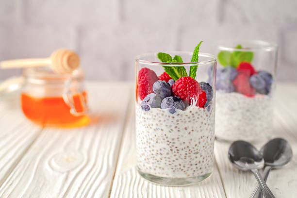 istock Healthy vanilla chia pudding in a glass with fresh berries and honey 2148989484