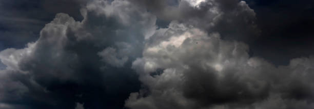 istock Banner Dramatic dark storm clouds black sky background. Dark thunderstorm clouds rainny season. Panorama Meteorology danger windstorm disasters climate. Dark cloudscape storm cloud with copy space. 2148990125