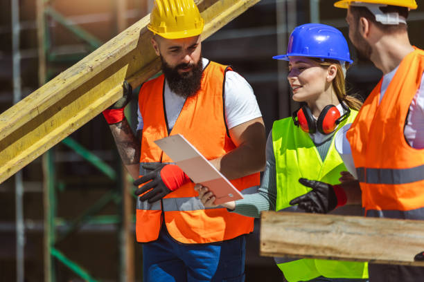 istock Construction team planning a building blueprint project on site with collaboration for architect innovation. 2148991030