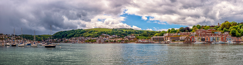 Boats sailing on Dartmouth lake with city skyline in background at Dartmouth, England, United Kingdom.