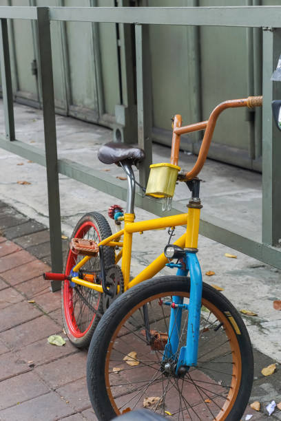 istock Bicycle parked on the sidewalk near the iron fence 2148993443