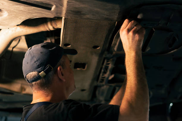 istock At a service station a car mechanic inserts metal panel under the car 2148993712