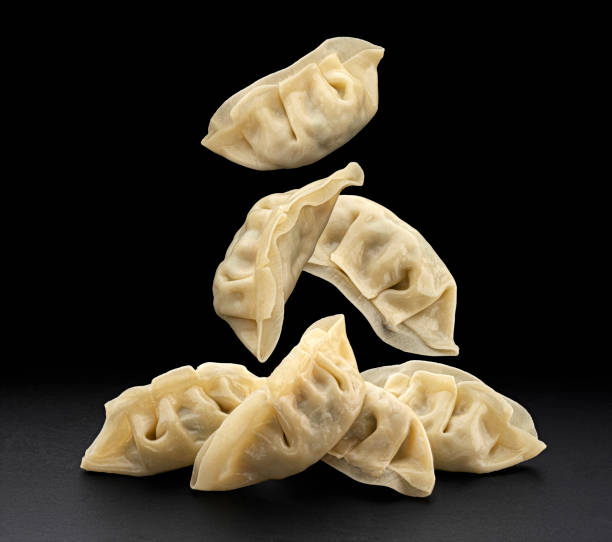 istock Chinese Gyoza dumplings isolated on black background 2148994703