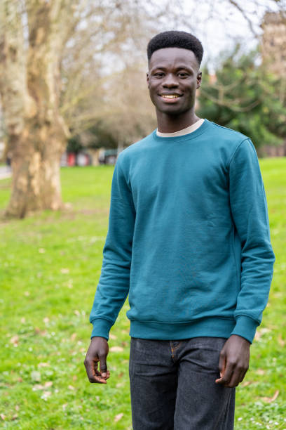 istock A young man wearing a blue sweater stands in a grassy field 2148995069