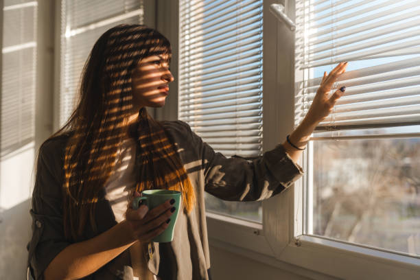 Side portrait of a woman looking through a window