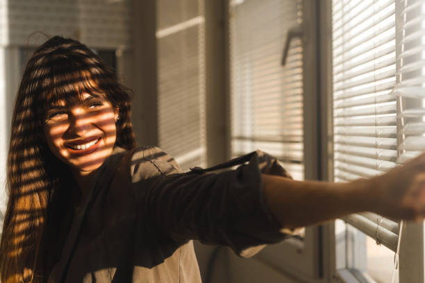 istock Enjoying the sunset next to a window 2148998733