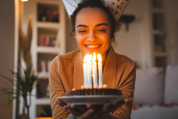 istock Mixed-race woman makes a birthday wish 2148999240