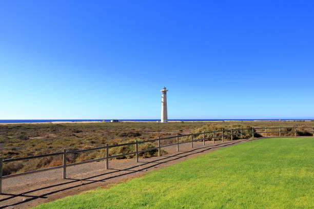 istock Faro de Morro Jable, Lighthouse on Morro Jable beach on Jandia peninsula in sunrise light, Fuerteventura, Canary Islands, Spain 2148999399