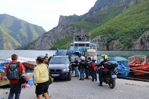 September 20 2023 - Lake Koman in Albania: people and cars waiting at the Ferry pier for crossing the lake