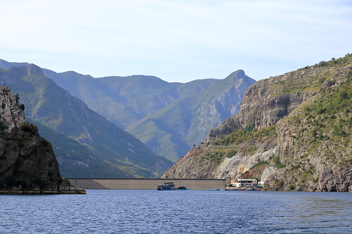 September 20 2023 - Lake Koman in Albania: people at a ferry in front of the dam