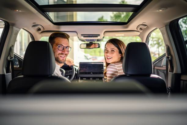 istock Young happy couple sitting inside their new car 2149001952