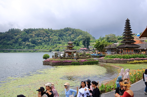 Bali in Indonesia - February 02 2024: people visit the Pura Ulun Danu Beratan Bratan temple