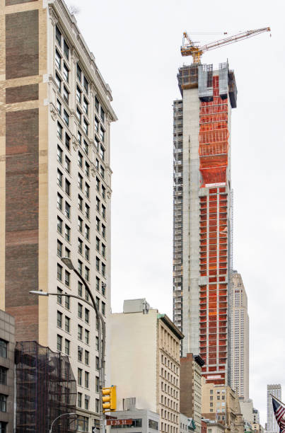 Buildings near the Empire State building on Fifth avenue.  This is a new build skyscraper with a crane.