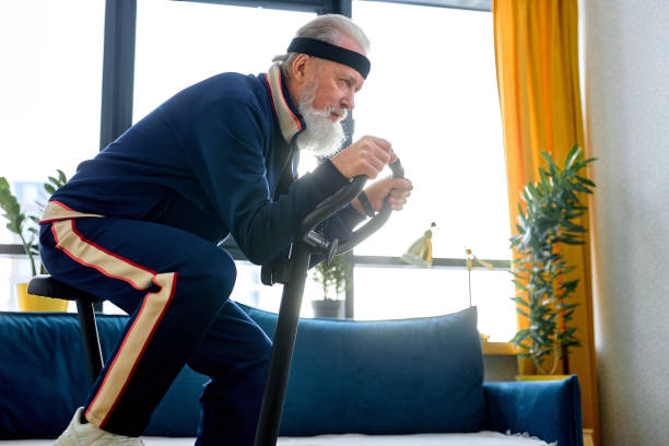 istock Elderly person training on stationary bicycle doing physical exercise and activity. 2149002642