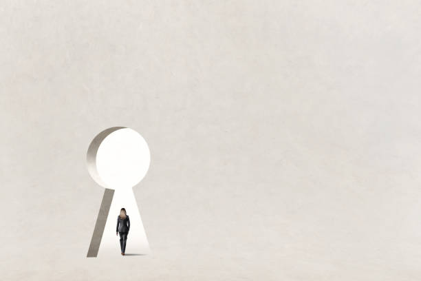 A woman walks through a large keyhole in a building that represents opportunity.