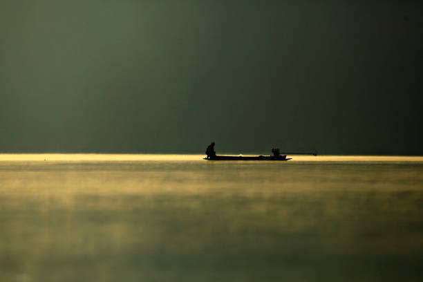 Minimalistic picture on the fishing boat in the sea at sunrise