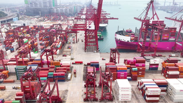 Overall busy activity in Hong kong Asia port. Global supply chain and transportation concept related with shipping and business. Drone video moving forward slow motion.