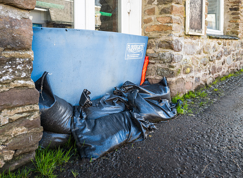 Aberfoyle, Scotland - Close up of sandbags and a Floodgate water barrier, in place to protect a home from floodwater.