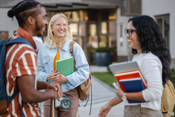 istock Group of students holding books and chatting 2149007632