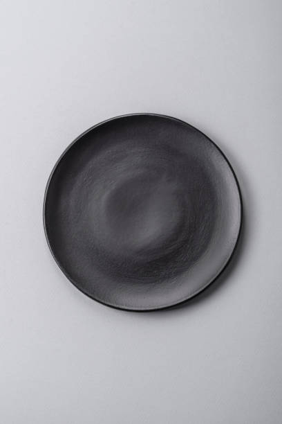 istock An empty plate on a gray concrete background with copy space 2149007766