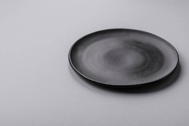 istock An empty plate on a gray concrete background with copy space 2149007767