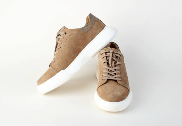Pair of comfortable suede shoes on white background