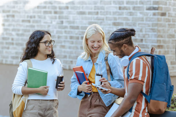 istock Group of students using smart phone on the street 2149009006