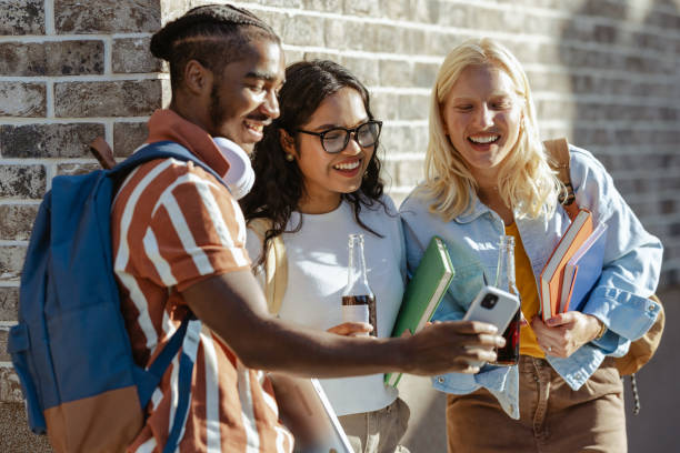 istock Group of students using smart phone on the street 2149009007