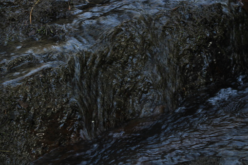 Water trickling Over Rocks In A Rural Creek In WV
