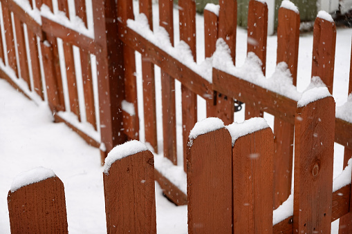 Falling Snow on wooden fence