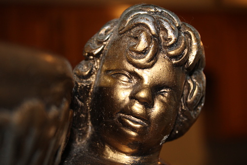 Angel Statue Face Up Close On A Planter