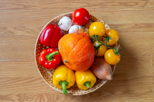 Basket, Bowl of colourful fruit and vegetables on a rustic wooden table