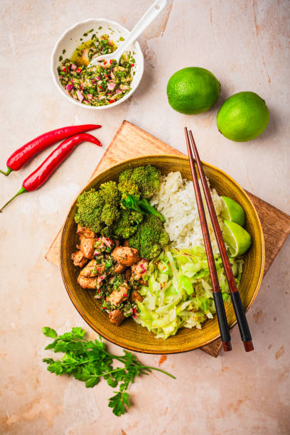istock Chicken bowl with rice, broccoli, cabbage and green Chimmichurri salsa 2149013648