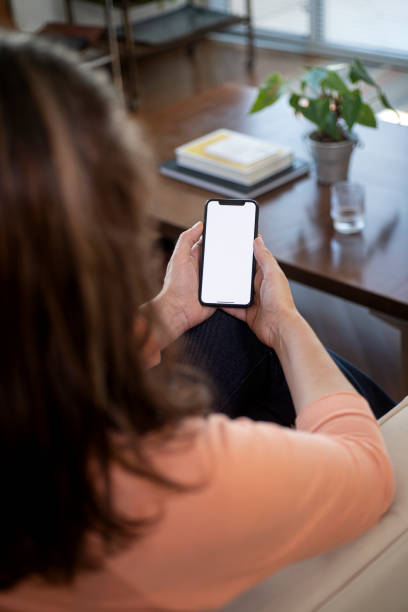 istock Sitting at home holding smartphone. 2149013998