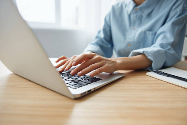 istock Closeup shot of woman's hands typing documents report answer using laptop keyboard staying on the table in office. Modern Online Job Work in Social Media concept 2149014414