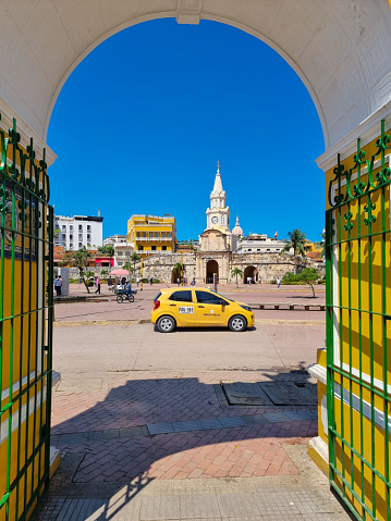 Colombia, Cartagena de Indias, view of the clock tower square, through an open entrance door