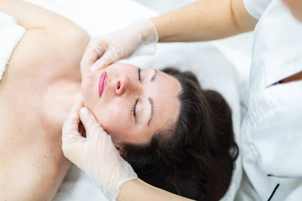 istock Cosmetologist making face massage to patient 2149015391