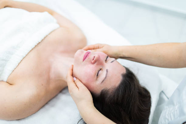 istock Cosmetologist making face massage to patient 2149015461