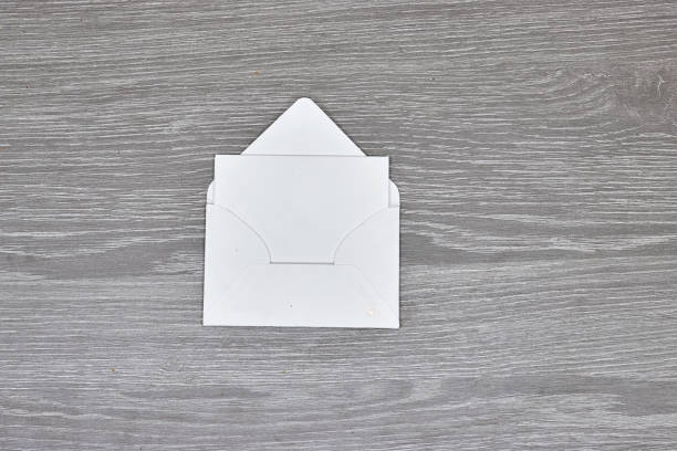 white envelope with Blank paper  on wood - White paper sheet on a dark wooden texture