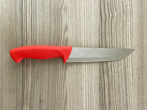 Kitchen knife on the wood background