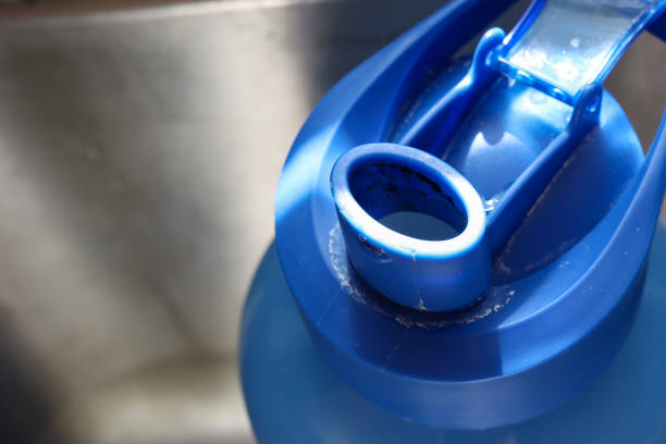 istock Cleaning a dirty reusable plastic water bottle in a kitchen sink 2149016775