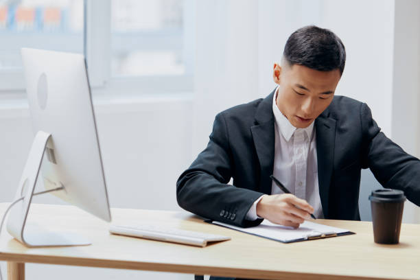 istock manager sitting at a desk in front of a computer emotions Lifestyle 2149016829