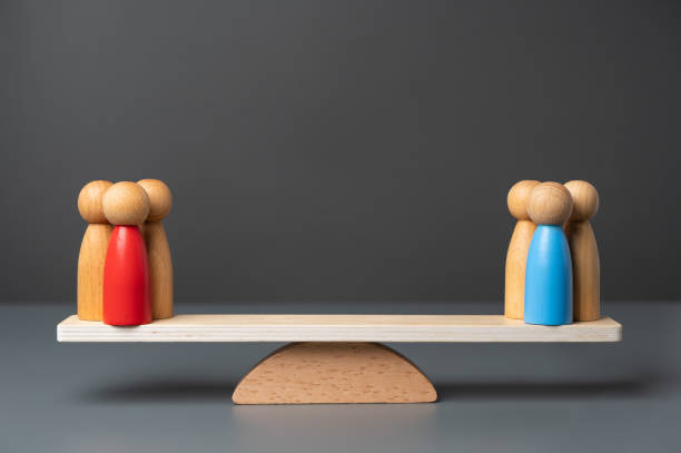 istock Two opposing teams on the scales. Rivalry between groups and leaders. The state and parties. Two major political parties. Democratic elections. 2149017096